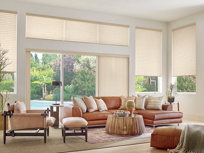 A living room with furniture in natural colors, brown and beige.